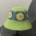 Detailed close-up of handmade crochet flower patterns on a green straw bucket sun hat - M(56-58cm) / Green