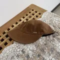 Brown wool felt bucket hat with a vintage metal logo and adjustable drawstring cord - M (56-58cm) / Camel