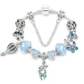 Silver charm bracelet with blue glass beads, starry charms, and green reindeer pendant - 16cm