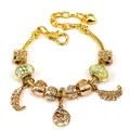 Gold plated bead bracelet with tree of life and feather charms and green glass beads - Style 006