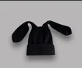 Detail of soft black knitted beanie with long rabbit ears for winter warmth and style - Black