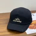Close-up of the OULEZEANG embroidery on a black cotton 5-panel camper cap - M / Black