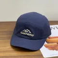 Navy blue five-panel short brim baseball cap with mountain embroidery on wooden desk - M / Navy Blue