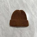 Detailed view of the dark brown ribbed knit pattern and soft texture on a winter beanie - M (56-58cm) / Coffee