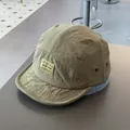 Detail of 5-panel camper hat showing olive green quick-dry fabric and brand woven label - M / Army Green