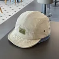 Off-white quick-dry five-panel camper hat with woven label for sun protection and outdoor style - M / Off White