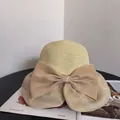 Elegant beige woven straw sun hat with a large organza bow for summer beach vacation - M / Khaki