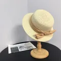 Elegant French style straw boater hat with a champagne satin ribbon and bow on a stand - M (56-58cm) / Beige