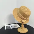 French style flat top straw boater hat with ribbon bow on a wooden stand - M (56-58cm) / Khaki