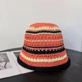 Detailed close-up of handmade crochet bucket hat with vibrant contrast stripes and black brim - M (56-58cm) / Red