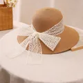 Straw sun hat with wide brim and white lace bow decoration for beach vacations - M (56-58cm) / Khaki