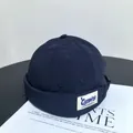 Detail of dark blue brimless docker cap with white embroidered Camping label - M(56-58cm) / Navy Blue