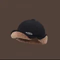 Detail of winter trapper hat featuring black corduroy and brown faux lamb wool lining - M (56-58cm) / Black