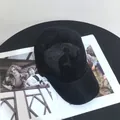 Top view of a breathable black mesh baseball cap on a magazine with a hollow knit texture - M (56-58cm) / Black