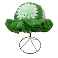 Detailed knit texture of green crochet bucket hat with wavy brim and floral top pattern - M / Green