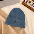 Detailed knit texture of a blue beanie with a signature R letter embroidery on soft fabric - M / Sky Blue