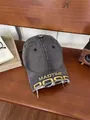 Close-up of vintage washed denim baseball cap with yellow embroidery and frayed brim detail - M / Gray