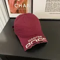 Detailed view of embroidery and distressed edge on the burgundy washed cotton baseball cap - M / Burgundy