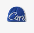 Detail of blue knitted beanie featuring white jacquard Cana lettering and woven label - M (56-58cm) / Blue