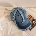 Close-up of frayed edges and stitching on a vintage light blue denim baseball cap - M (56-58cm) / Medium Blue
