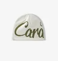 Detail of cream knit beanie with green jacquard lettering and stitched design label - M (56-58cm) / White