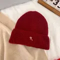 Detailed view of the dark red ribbed knit beanie featuring a white 'R' letter embroidery - M / Burgundy
