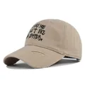 Close-up of khaki baseball cap featuring distressed brim and black graffiti text embroidery - M (56-58cm) / Khaki