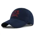 Detail of navy blue cotton baseball cap with red text embroidery and distressed vintage holes - M (56-58cm) / Navy Blue