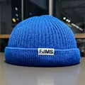 Detailed close-up of vibrant royal blue knit docker hat with FJMS woven label - M / Blue