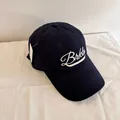 Detailed view of navy blue baseball cap with white Brkln embroidery and product tag - M (56-58cm) / Navy Blue