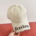 Dettaglio del cappellino in tela crema con ricamo Freedom e fori con effetto invecchiato - M(56-58cm) / Bianco avorio