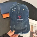 Close-up of distressed denim baseball cap with vintage red 7 and slogan embroidery detail - M(56-58cm) / Dark Denim