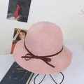 Detail of pink knitted sun hat with wavy brim and dark brown decorative bow ribbon - M / Pink