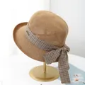 Detail of woven sun hat featuring a brown plaid ribbon bow and golden metal brand tag - M (56-58cm) / Khaki