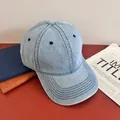Detail view of light blue washed denim baseball cap with six-panel structure and stitching - M (56-58cm) / Light Blue
