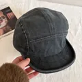 Detail of five-panel washed denim camper cap in dark grey cotton twill on lifestyle background - M (56-58cm) / Gray