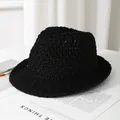 Close-up of breathable hollow-out crochet texture on a black summer straw sun hat - M / Black