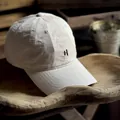 Close-up of letter H embroidery on a beige washed cotton baseball cap with stitched brim - M (56-58cm) / Off White