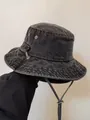 Close-up of charcoal denim bucket hat with metal eyelets and adjustable windproof cord - M (56-58cm) / Black