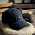 Vintage washed black cotton baseball cap with embroidered letter H on wooden stand - M (56-58cm) / Black