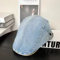 Close-up of washed denim ivy cap with yellow stitching and adjustable metal buckle - M (56-58cm) / Light Blue