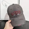 Close-up of distressed denim baseball cap with New York embroidery and ripped details - M (56-58cm) / Gray