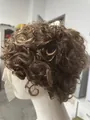 Short curly synthetic hair wig in natural brown color on white mannequin head - Tan