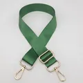 Detail view of emerald green adjustable nylon bag strap with gold metal lobster clasps - Grass Green