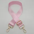 Detail of light pink nylon bag strap with polished gold-tone metal lobster clasps - Pink