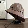 Close-up of vintage brown PU leather bucket hat with texture and windproof rope - M (56-58cm) / Brown