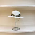 Flat top straw sun hat with leopard ribbon and pearl buckle on a display stand - M(56-58cm) / White