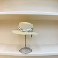 Close-up of beige straw boater hat with floral ribbon and triple-row pearl detail - M (56-58cm) / Beige