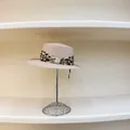 Chic pink straw sun hat with leopard print scarf and pearl detail on display stand - M(56-58cm) / Pink