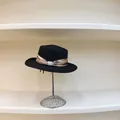 Detail of black straw boater hat with floral ribbon and elegant pearl buckle accent - M (56-58cm) / Black